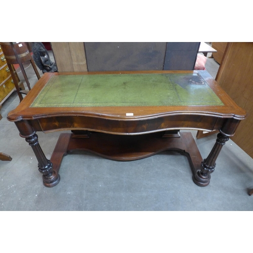 164 - A Victorian mahogany and green leather serpentine writing table