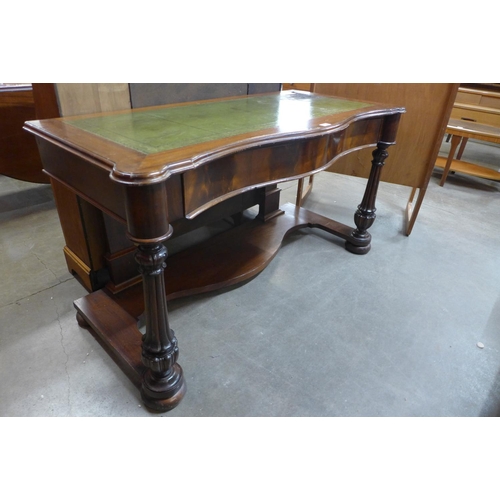 164 - A Victorian mahogany and green leather serpentine writing table