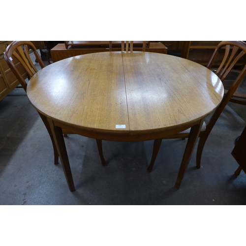 194 - A Nathan teak extending dining table and four chairs