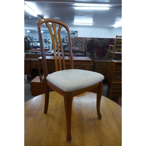 194 - A Nathan teak extending dining table and four chairs