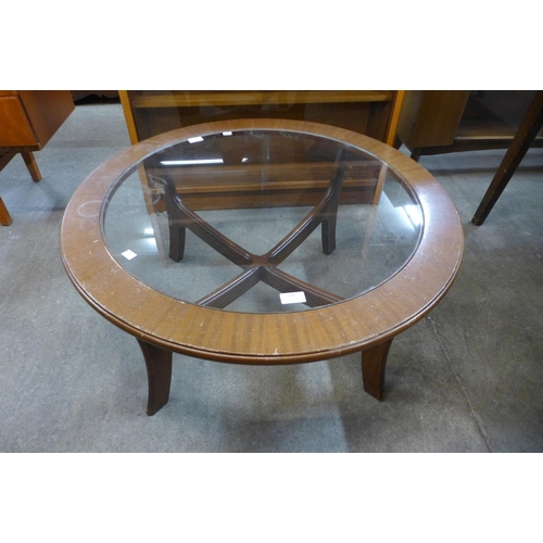 198 - A teak and glass topped circular coffee table