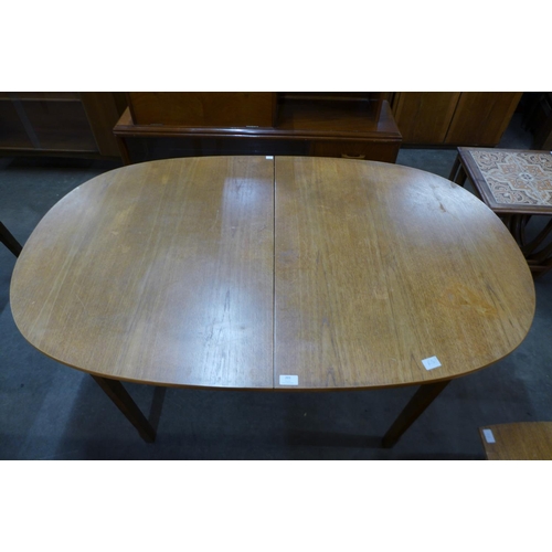 203 - A teak extending dining table