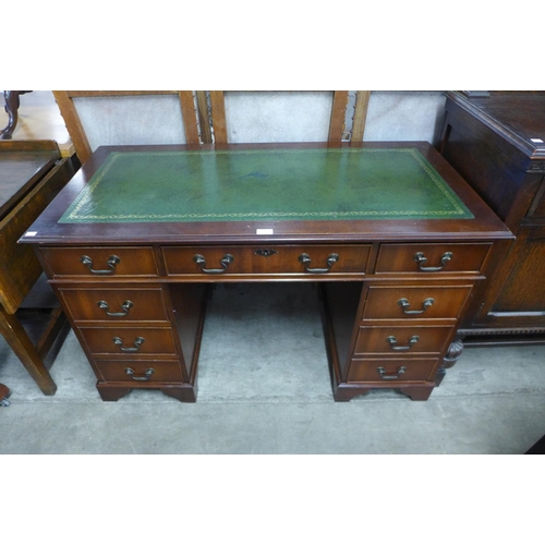 219 - A mahogany and green leather pedestal desk