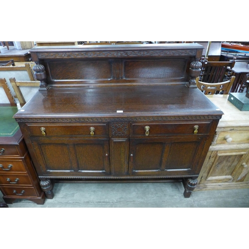 221 - A carved oak sideboard