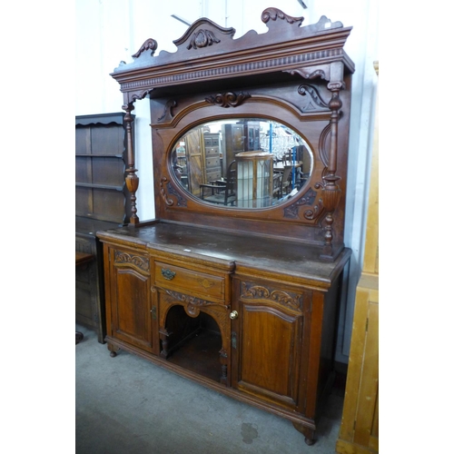 231 - A Victorian carved walnut mirrorback sideboard