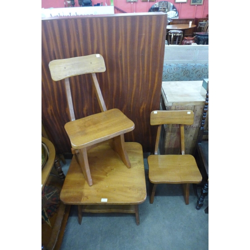 250 - A Cotswold School child's elm table and two chairs