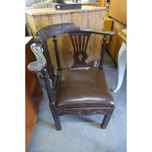 261 - A George III carved oak corner chair