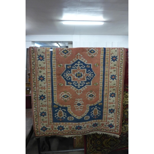 284 - A Turkish Kars salmon ground rug, 187 x 131cms