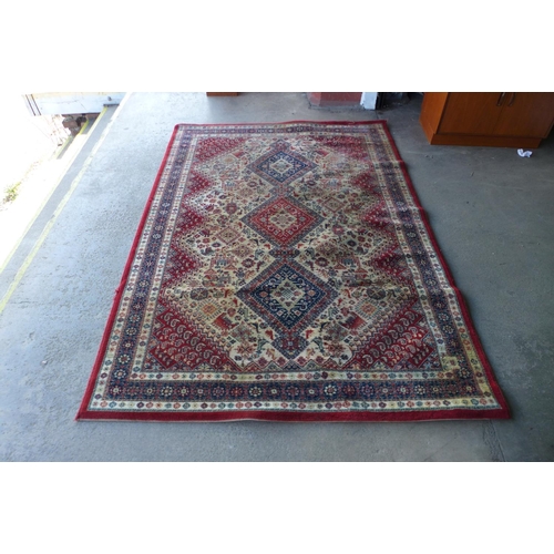 286 - A red and cream rug, 169 x 236cms