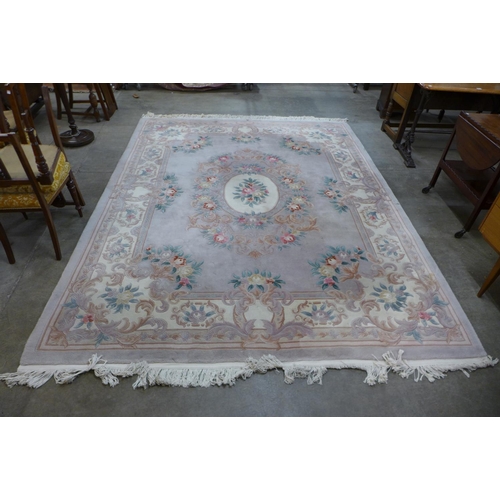 288 - A large Chinese pink ground rug