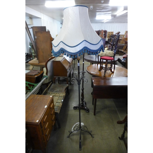 306 - A wrought iron standard lamp