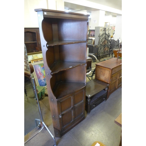 321 - A dark Ercol corner cabinet and a matching table