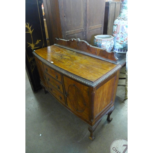 335 - A walnut bow front sideboard