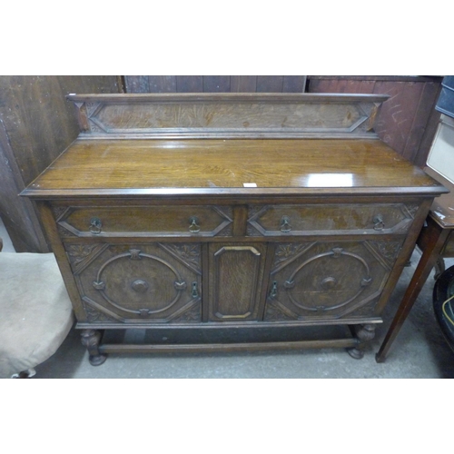 341 - A carved oak sideboard