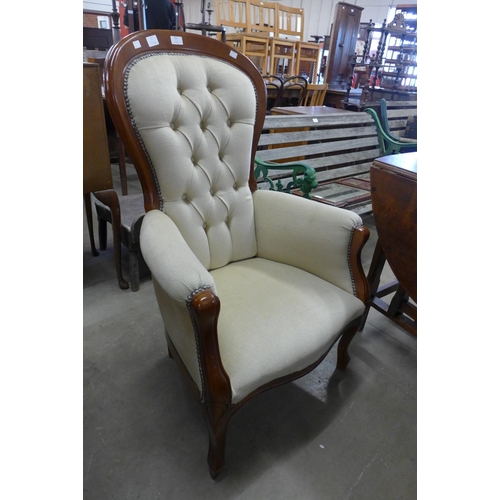 351 - A walnut and fabric upholstered button back armchair