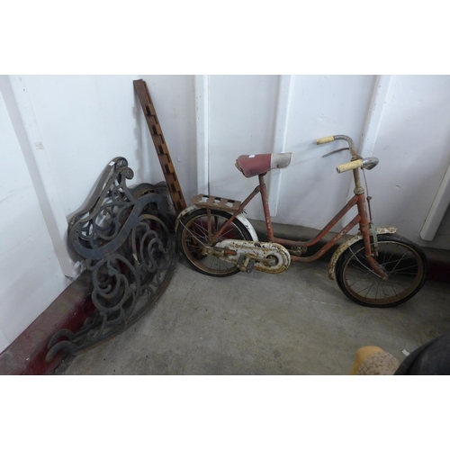 358 - A pair of rocking garden bench ends and a vintage Sunbeam child's bicycle