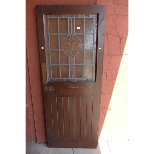 375 - A stained pine and leaded glass door