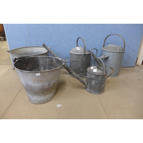 398 - Three galvanised watering cans and two buckets