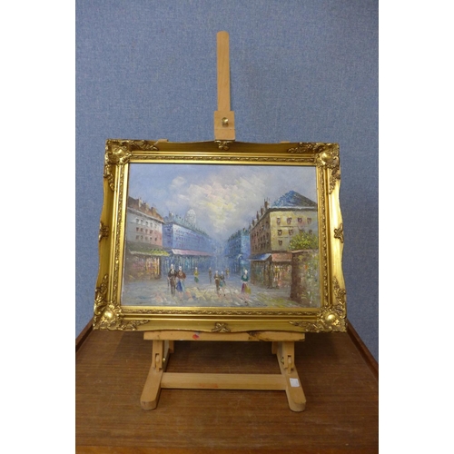 426 - An artist's easel and a small French oil painting