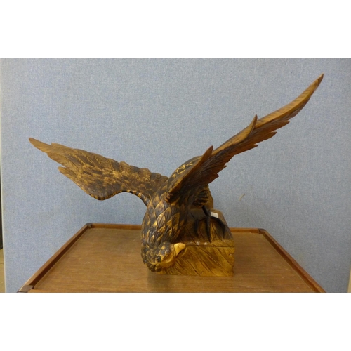 445 - A carved oak figure of an eagle