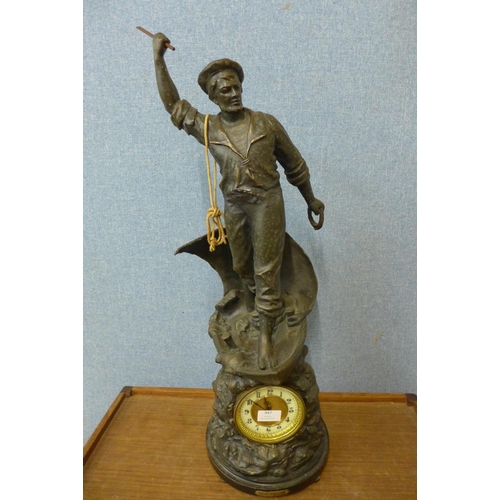 447 - A large 19th Century spelter figural  mantel clock, titled  Cod Fishing, 75cms h