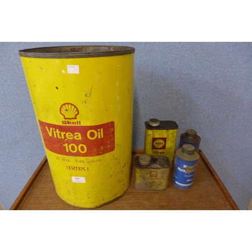 458 - An enamelled Shell oil drum and four oil cans