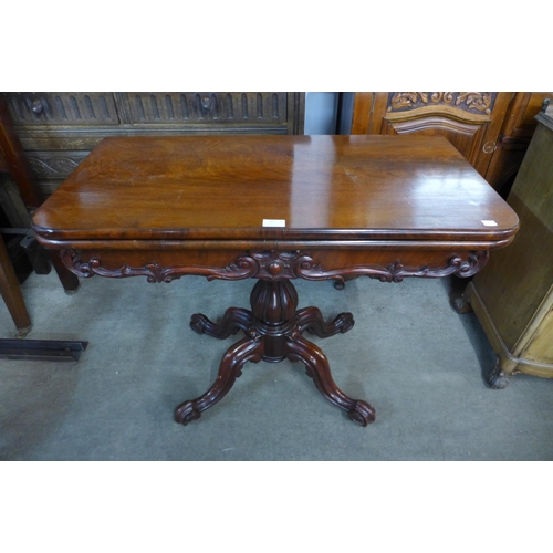 82 - A Victorian mahogany fold over card table