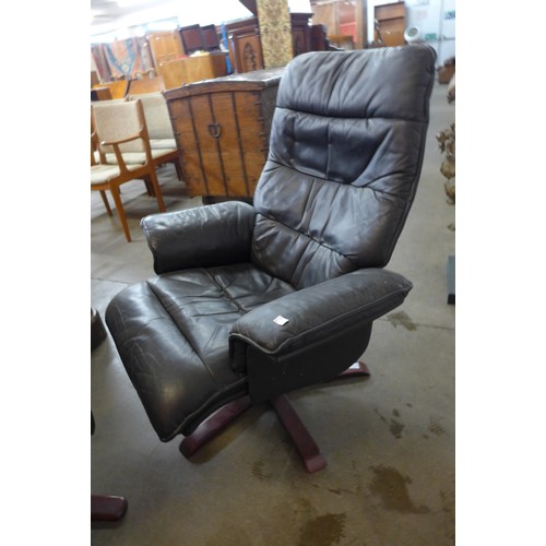 348a - A black leather swivel armchair and two stools