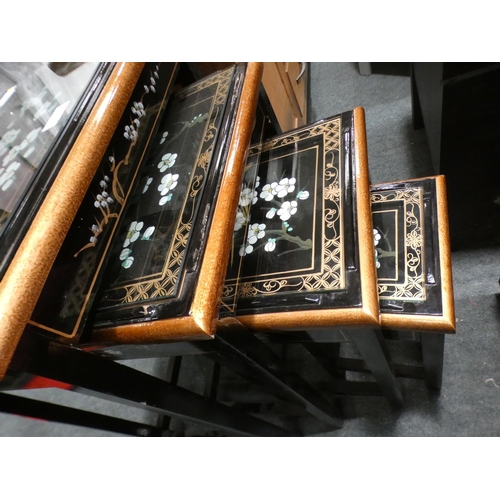 3160 - A traditional patterned black and glass topped nest of four tables (minor cracks/damaged) * This lot... 