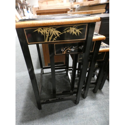 3160 - A traditional patterned black and glass topped nest of four tables (minor cracks/damaged) * This lot... 