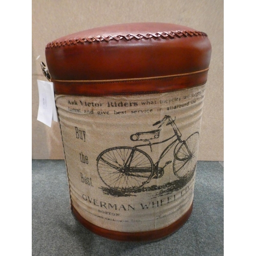 3179 - A tin upholstered bike print footstool * This lot is subject to VAT