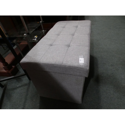 3202 - A grey fabric storage ottoman. Marked inside and outside * This lot is subject to VAT