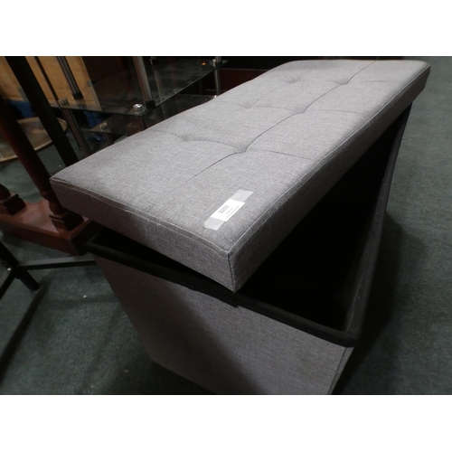 3202 - A grey fabric storage ottoman. Marked inside and outside * This lot is subject to VAT