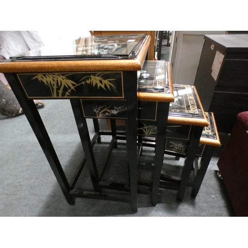 3160 - A traditional patterned black and glass topped nest of four tables (minor cracks/damaged) * This lot... 