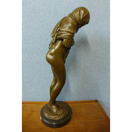 43 - A large French style bronze figure of a semi-nude bathing female, on black marble socle, 69cms h