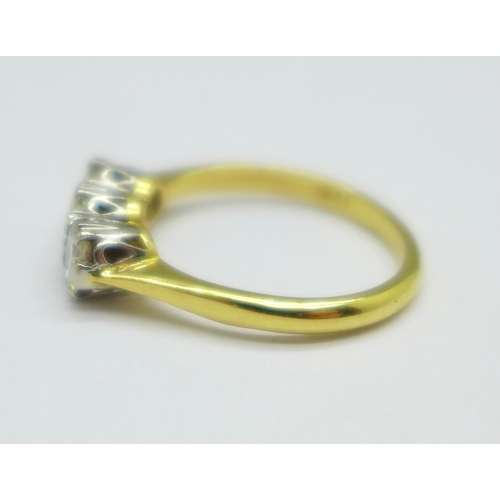 1049 - An 18ct gold, three stone diamond ring, approximately 1carat total diamond weight, 3.4g, O