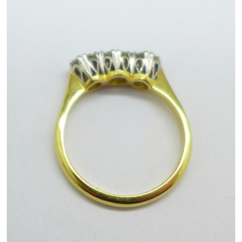 1049 - An 18ct gold, three stone diamond ring, approximately 1carat total diamond weight, 3.4g, O