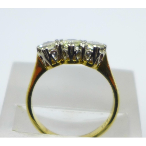 1049 - An 18ct gold, three stone diamond ring, approximately 1carat total diamond weight, 3.4g, O