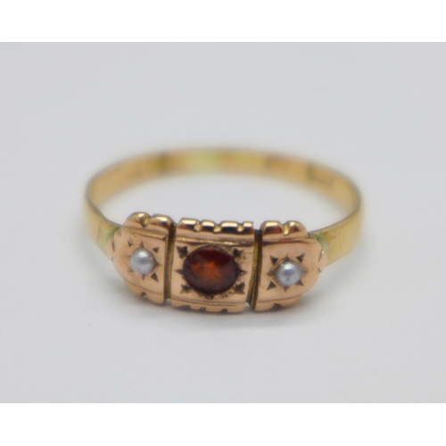 1061 - A yellow metal, garnet and pearl set ring, 1.7g, M, hallmark worn