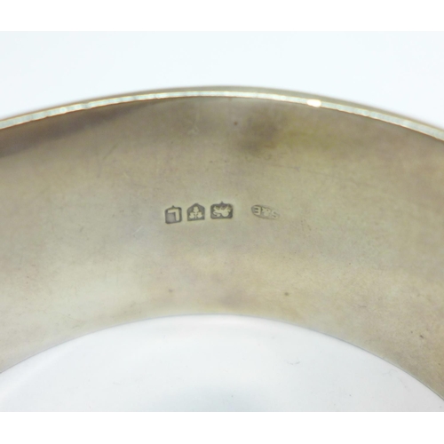 1078 - A wide hallmarked silver bangle, 44g, a/f, dented