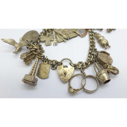 1126 - A silver charm bracelet, each link marked, 59g