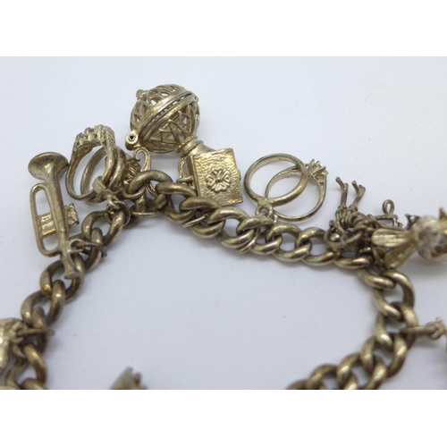 1127 - A silver charm bracelet, 56g