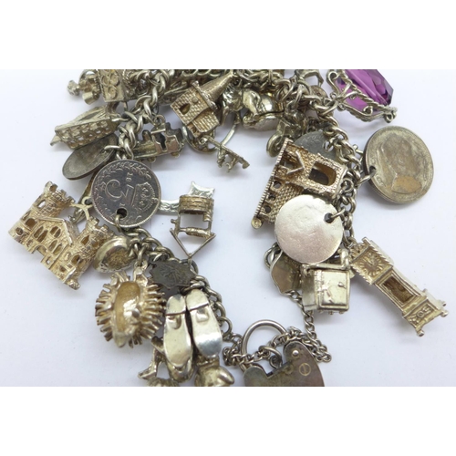 1128 - A silver charm bracelet, each link marked, 110g