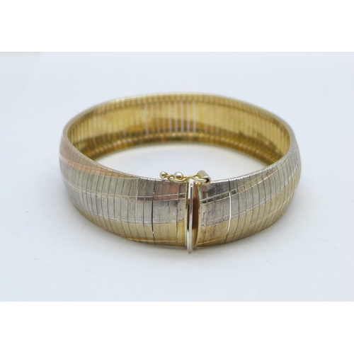 1134 - A silver gilt three colour bracelet, 25g