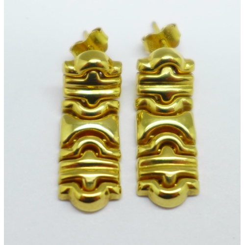 1165 - A pair of yellow metal earrings, the fasteners marked 750, the stems marked Italy, 5.6g