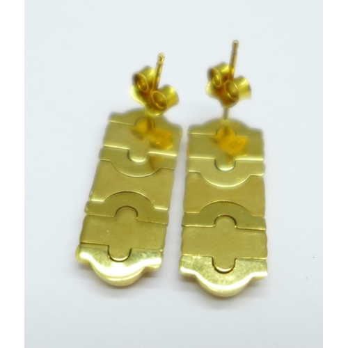 1165 - A pair of yellow metal earrings, the fasteners marked 750, the stems marked Italy, 5.6g