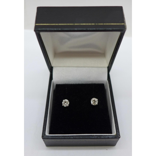 1183 - A pair of 18ct white gold, diamond stud earrings, 0.67ct total diamond weight