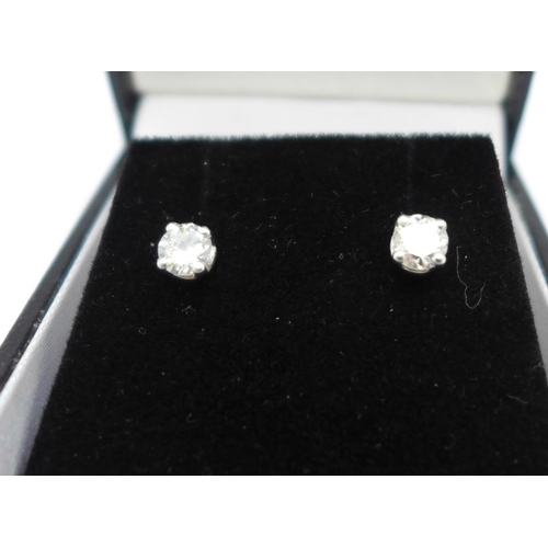 1183 - A pair of 18ct white gold, diamond stud earrings, 0.67ct total diamond weight