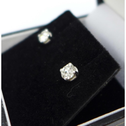 1183 - A pair of 18ct white gold, diamond stud earrings, 0.67ct total diamond weight