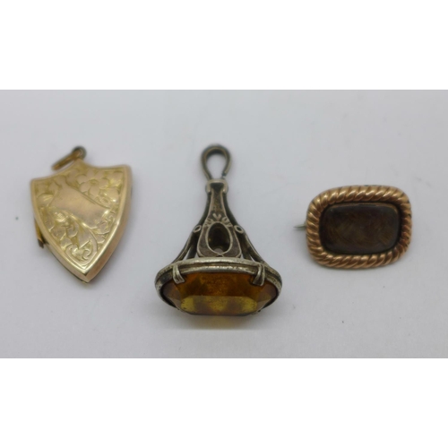 1188 - A 19th Century mourning brooch, a shield shaped locket and a seal fob, loop a/f